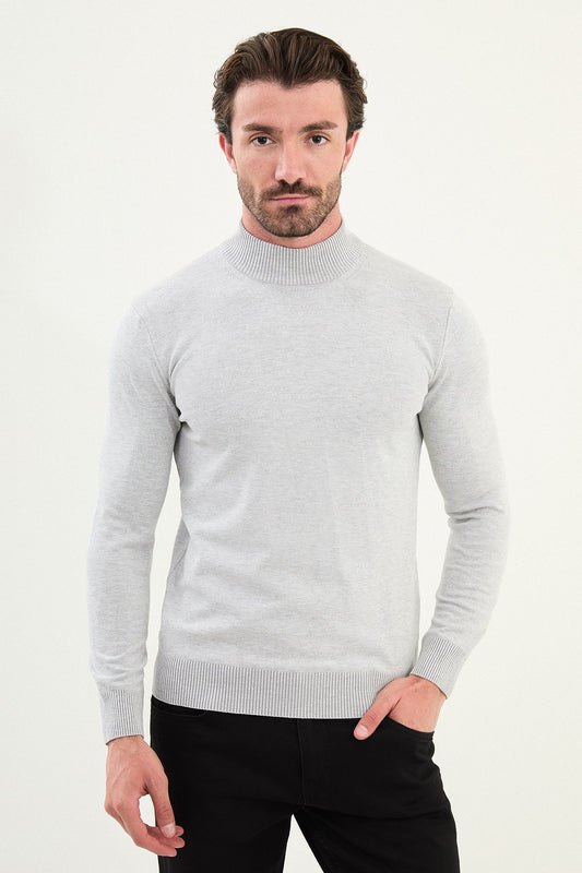 Man wearing a light gray sweater against a white background
