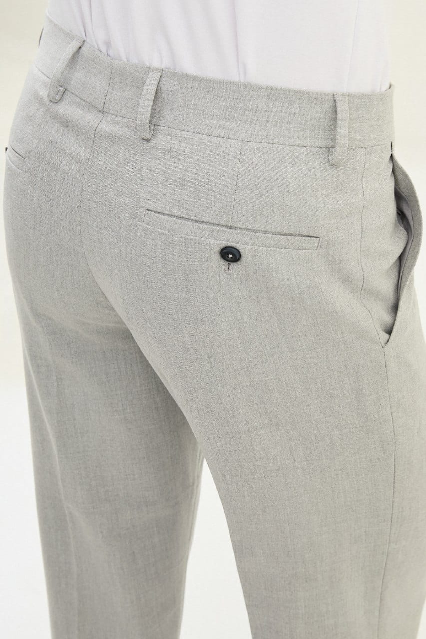 Gray suit pants with a button on a white background