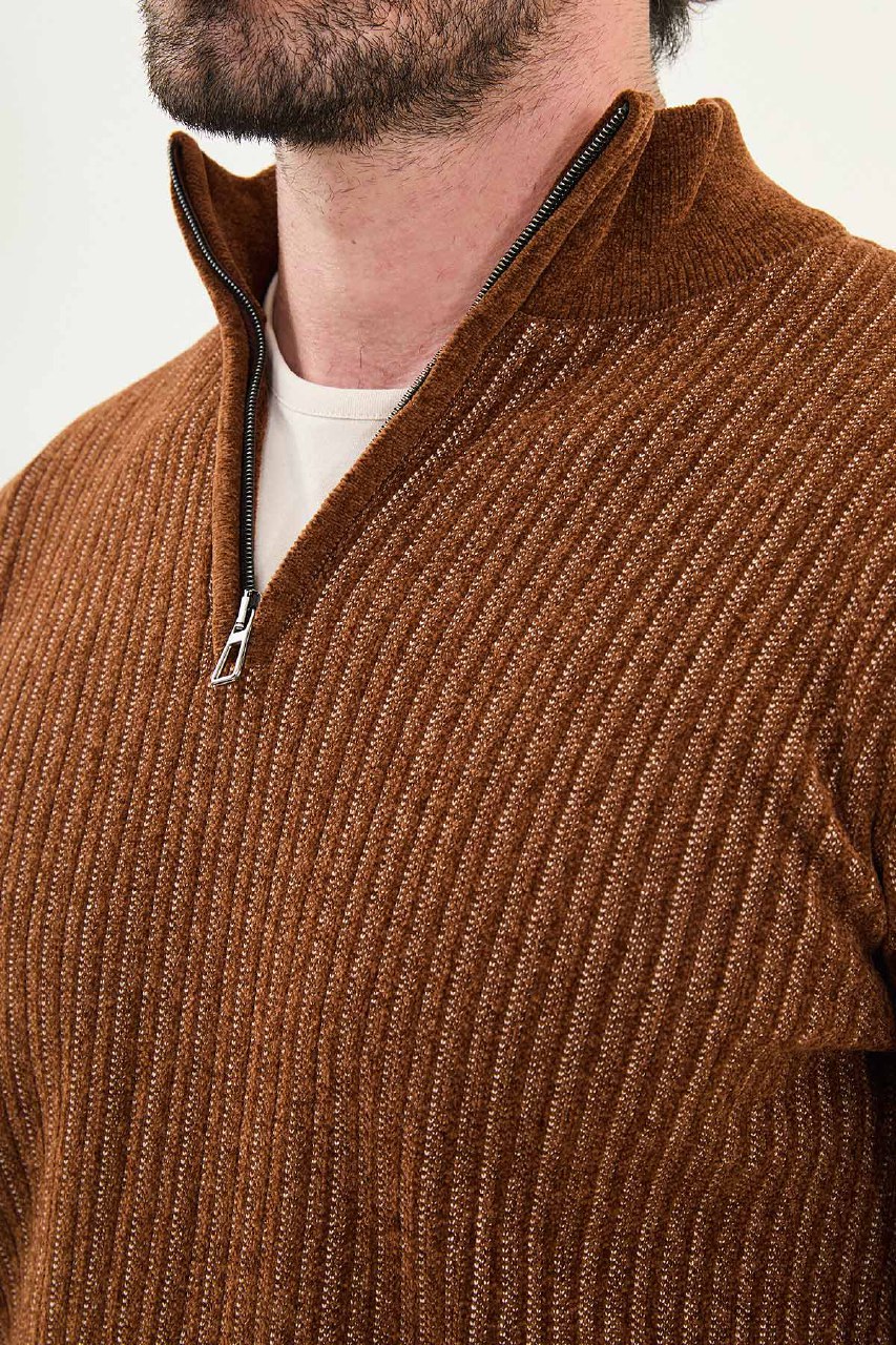 Brown ribbed sweater with a zipper on a plain background