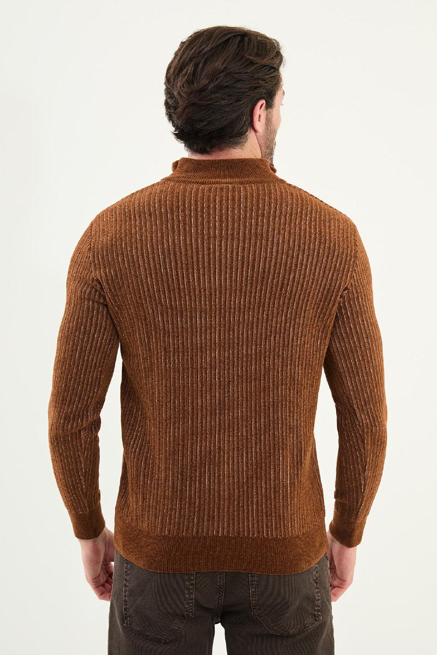 Man wearing a brown ribbed sweater on a white background