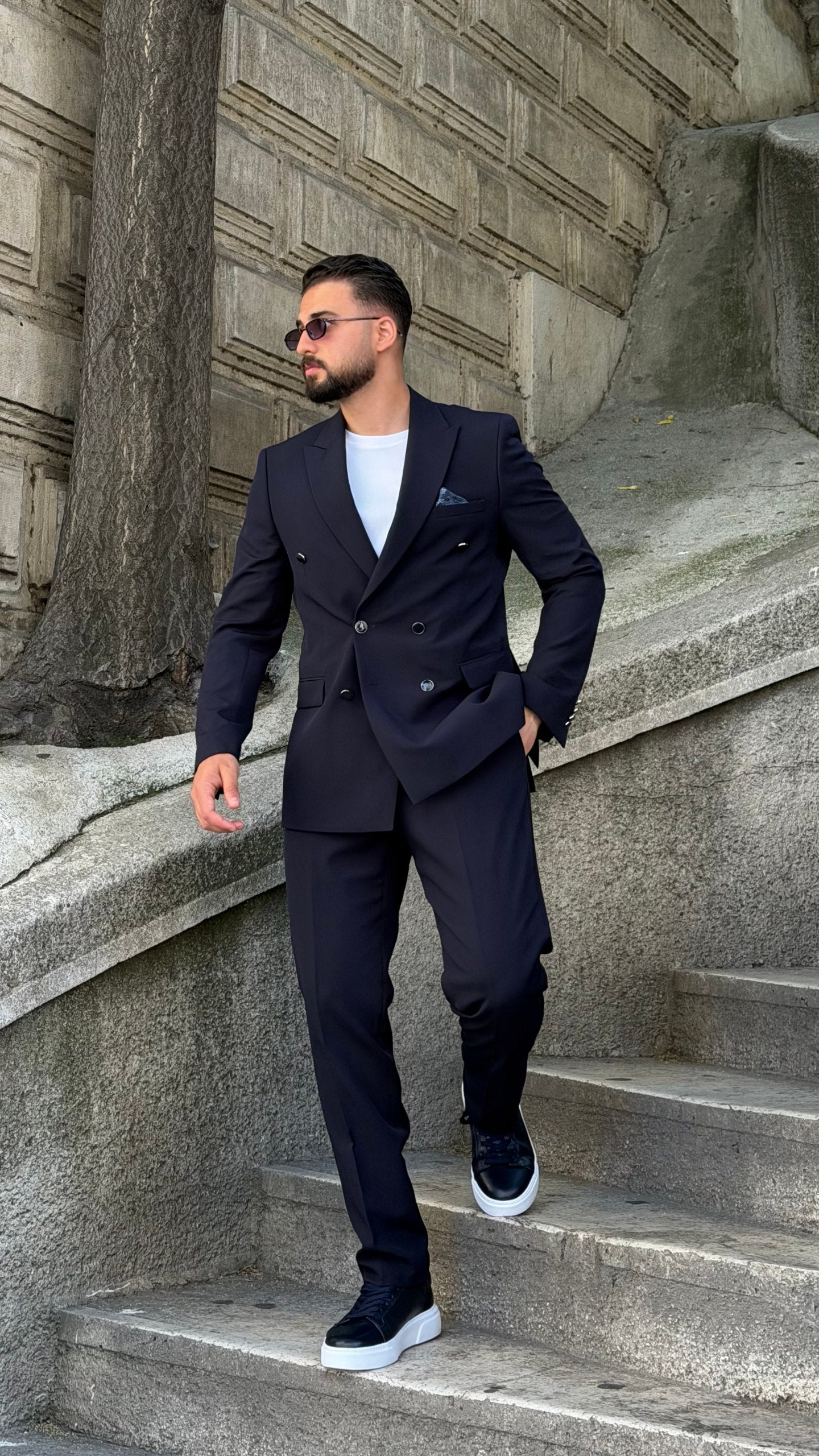 Full-length navy double-breasted suit with matching trousers