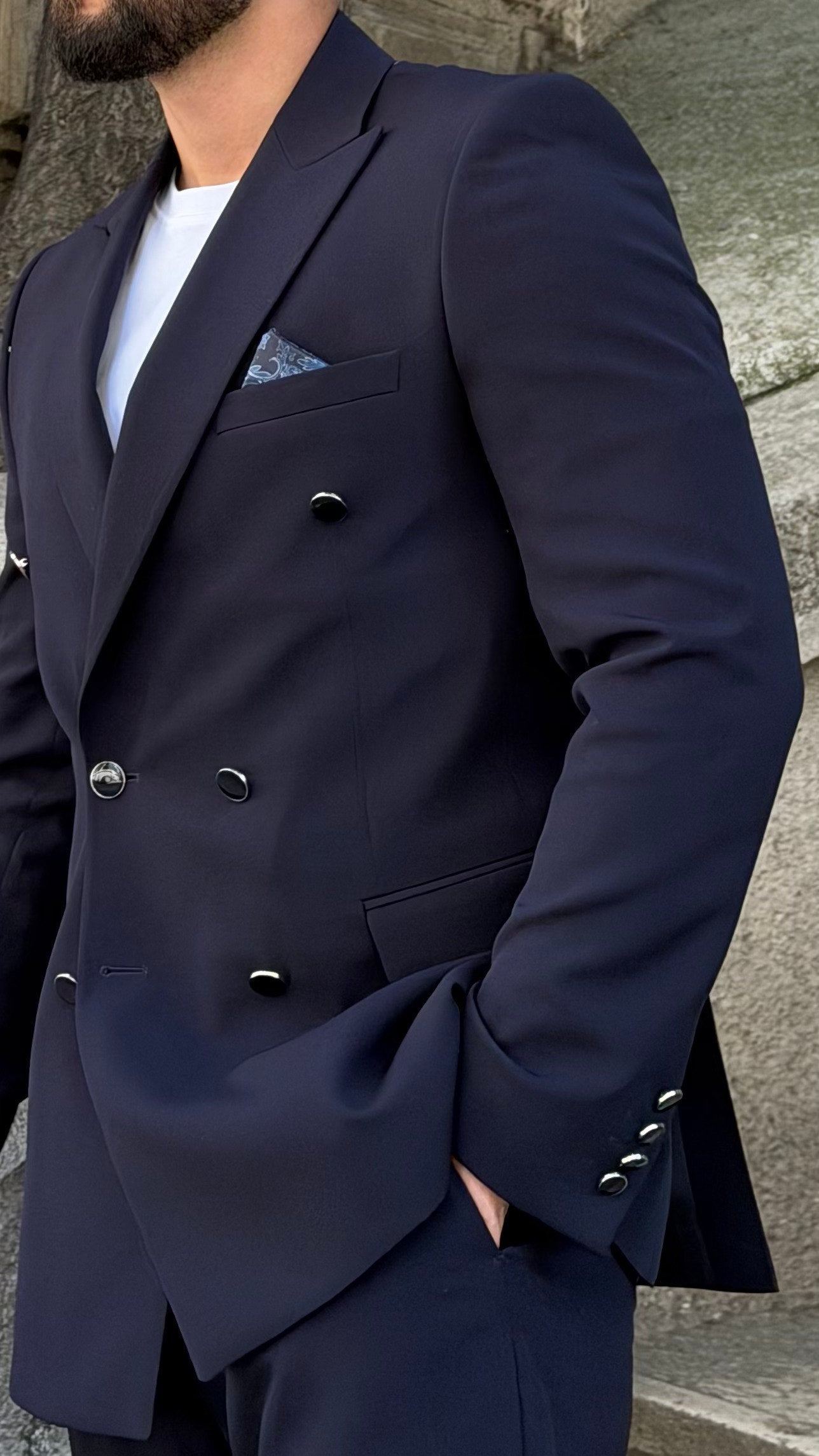 Men's navy wedding suit shown from an angled view
