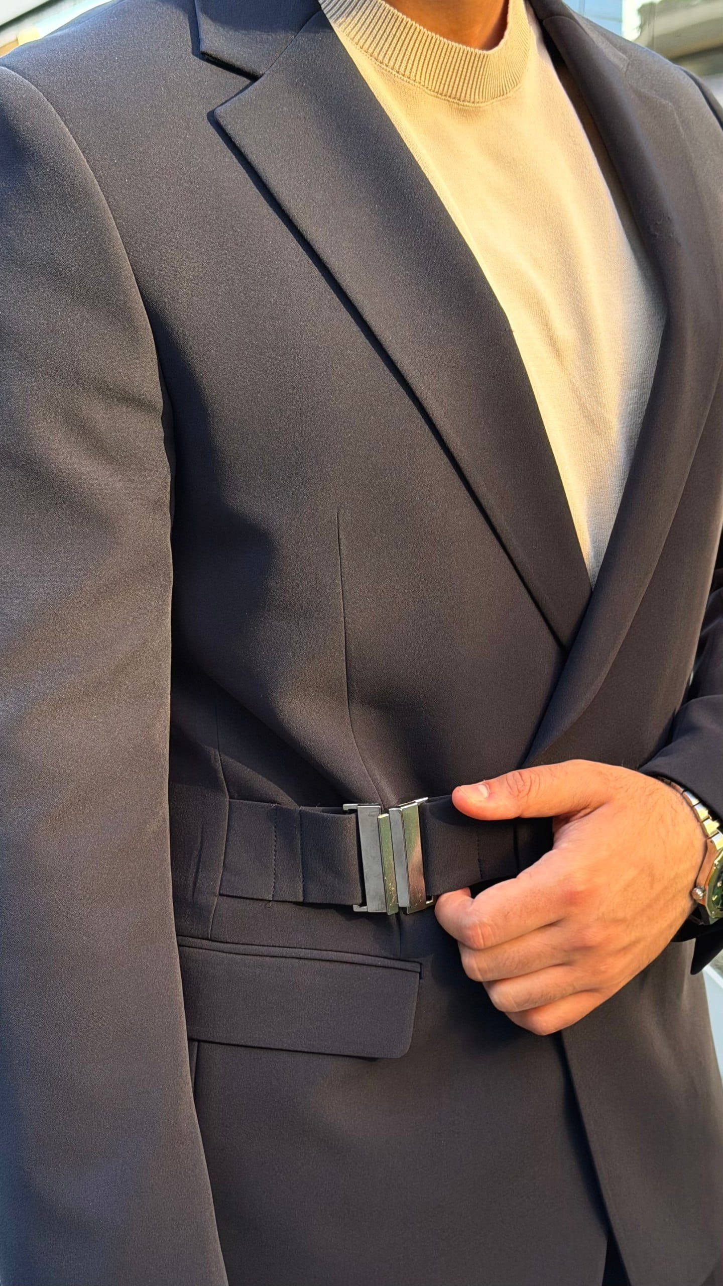 Navy two-piece business suit with contemporary buckle styling