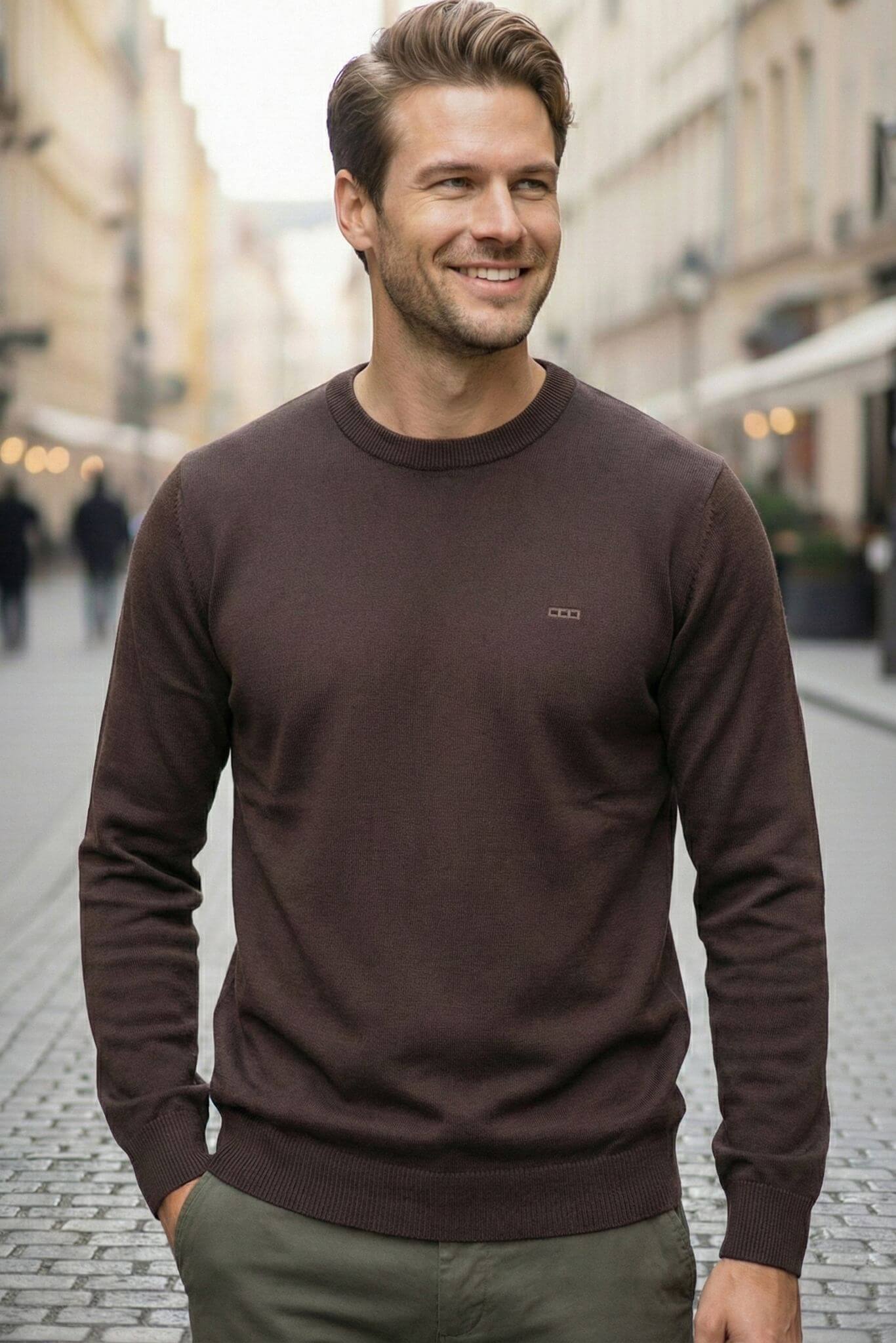Man wearing a brown sweater on a city street