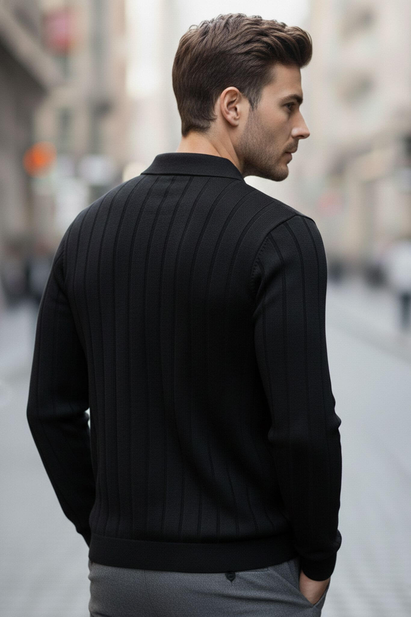 Man wearing a Slim-fit Ribbed Knitted Polo Sweater in Black walking down a city street