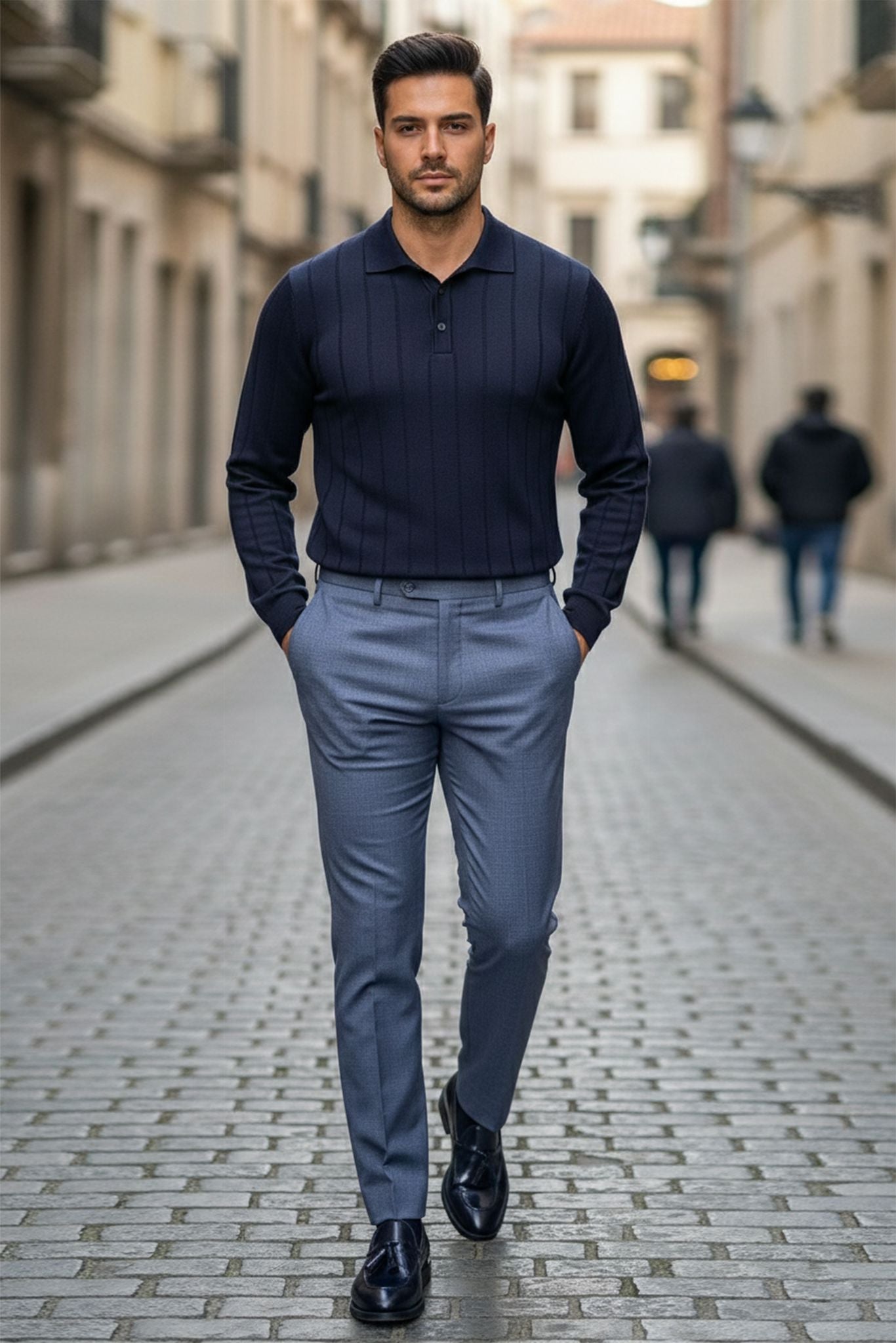 Man in Slim-fit Ribbed Knitted Polo Sweater in Navy Blue and gray pants walking down a city street.