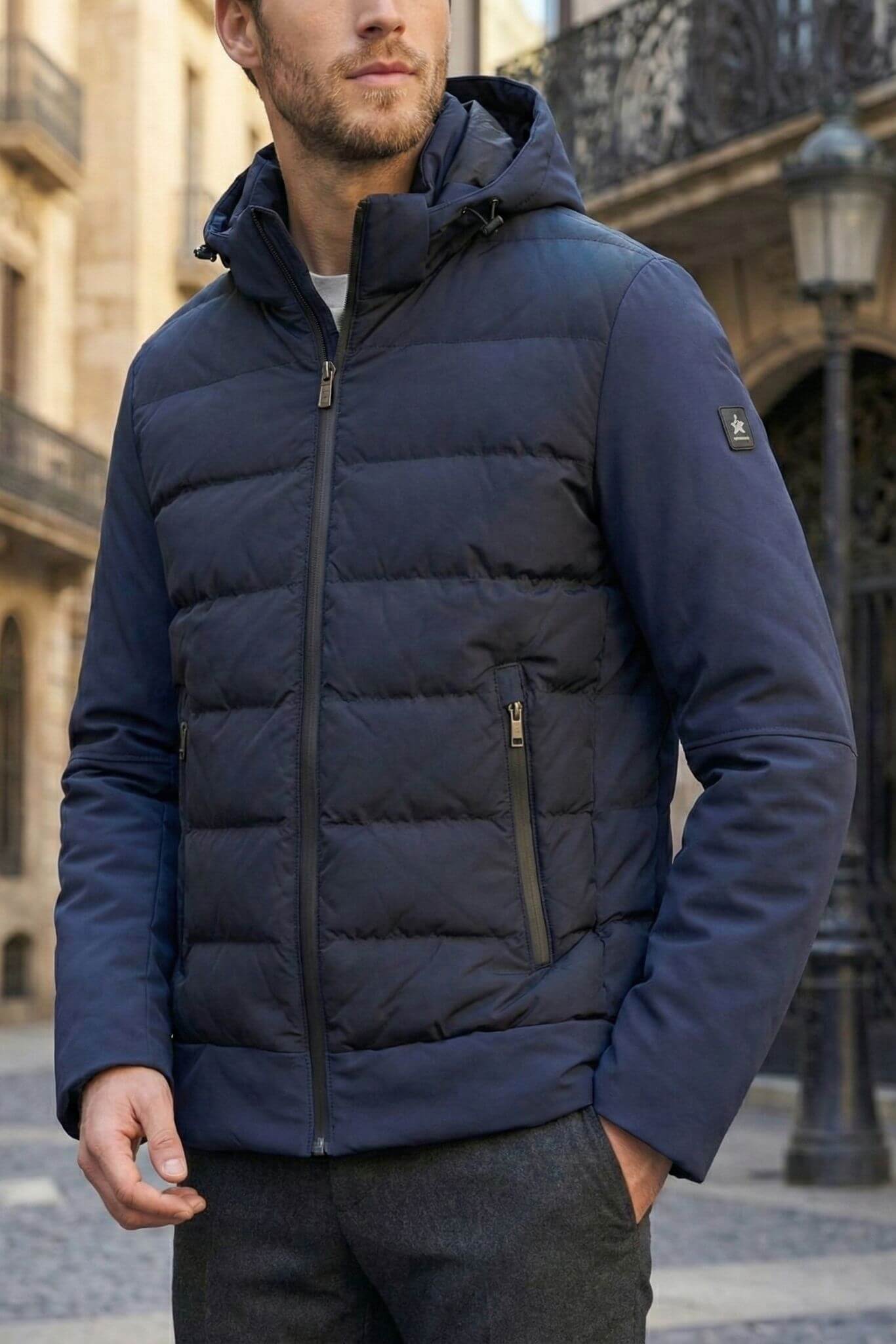 Man wearing a navy blue puffer jacket in an urban setting