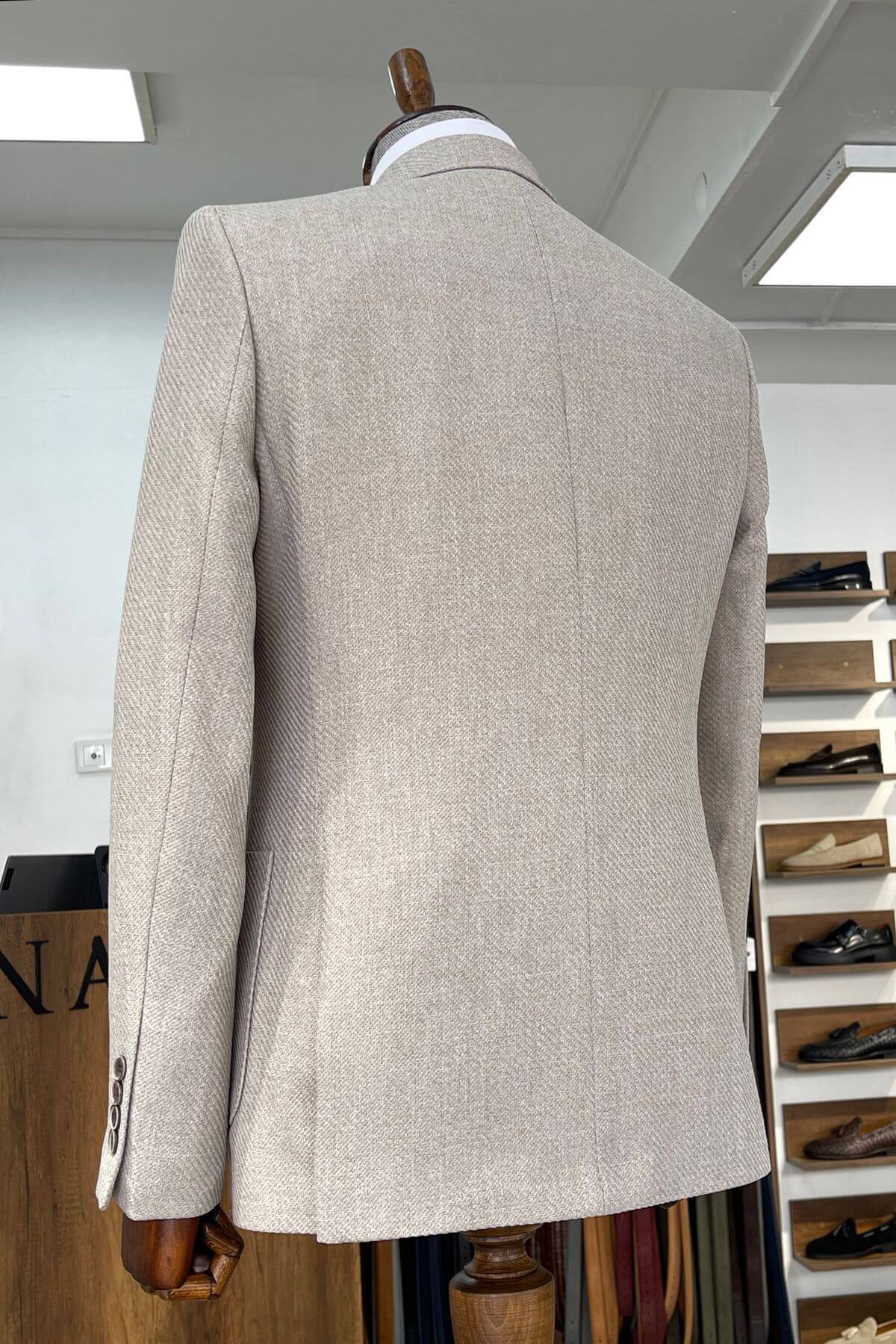Slim-fit Wool Blend Self-Patterned Blazer in Beige a mannequin in a store setting with shoes displayed in the background.