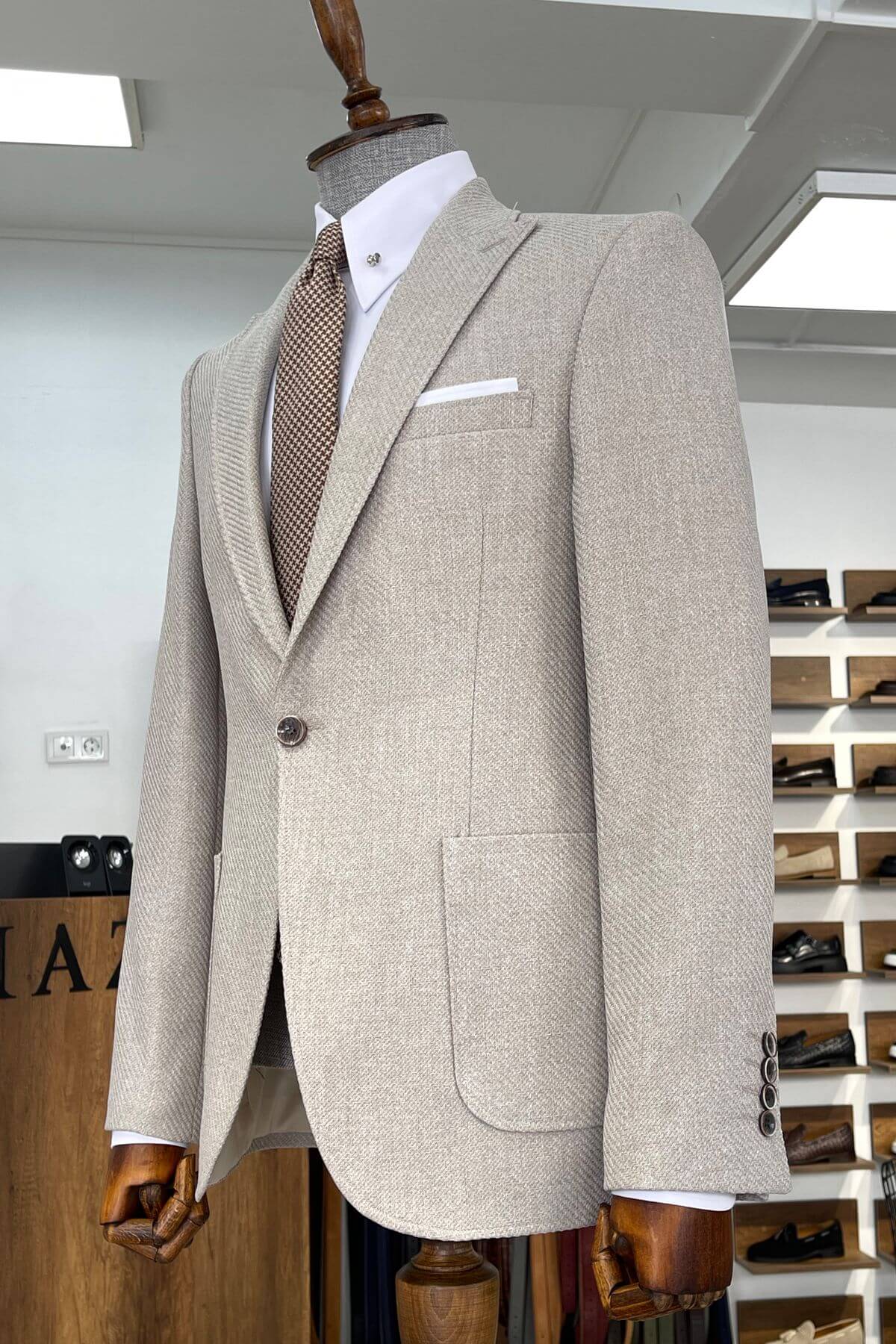 Slim-fit Wool Blend Self-Patterned Blazer in Beige on a mannequin in a store setting
