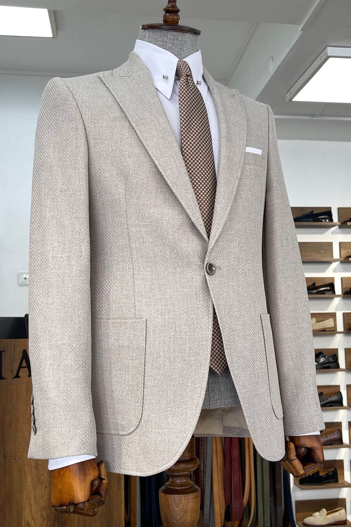 Slim-fit Wool Blend Self-Patterned Blazer in Beige on a mannequin with a white shirt and patterned tie in a store setting.