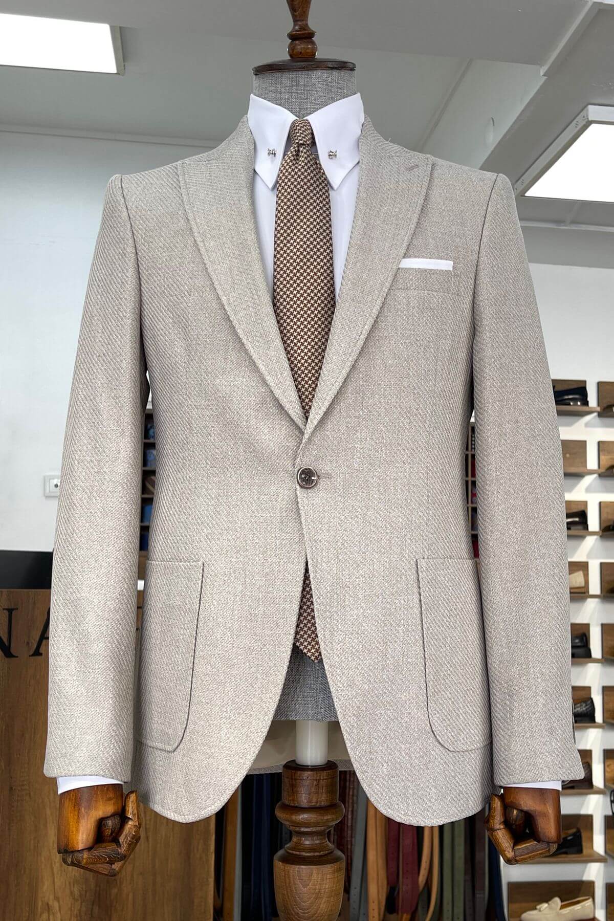 Slim-fit Wool Blend Self-Patterned Blazer in Beige on a mannequin with a white shirt and patterned tie in a store setting.