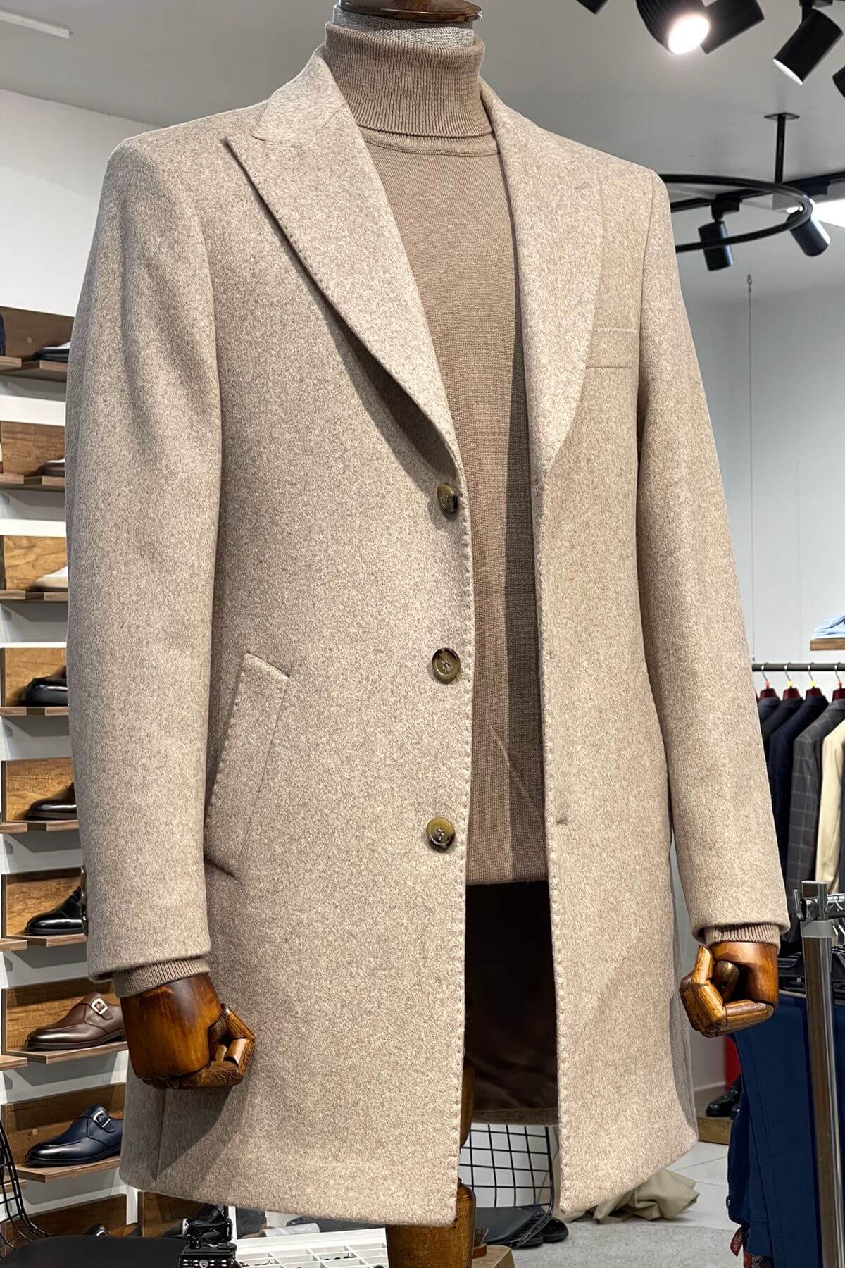 Beige overcoat on a mannequin in a store setting