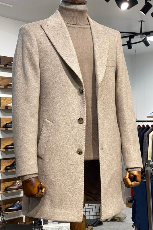 Beige overcoat on a mannequin in a store setting