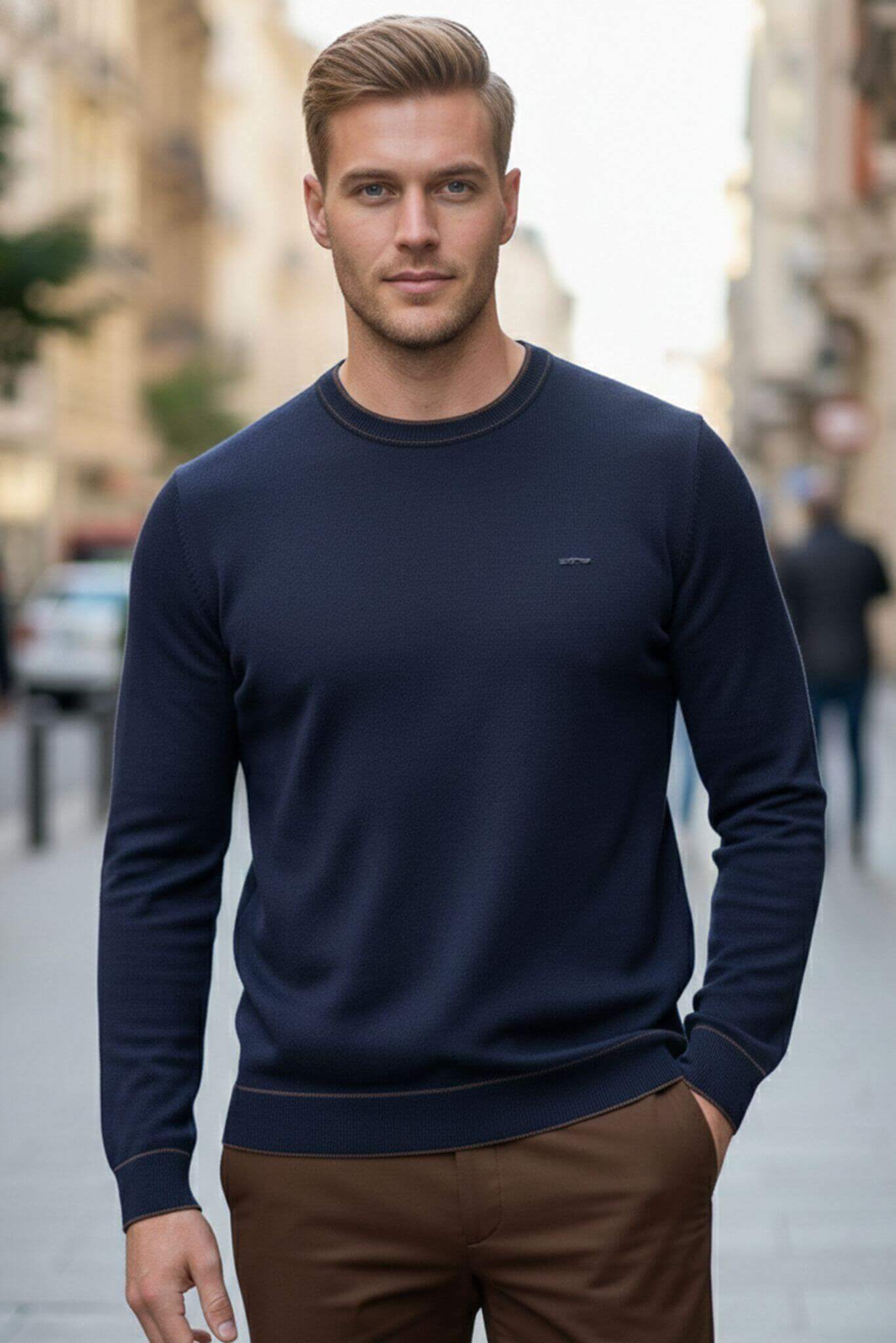 Man wearing a navy sweater on a city street