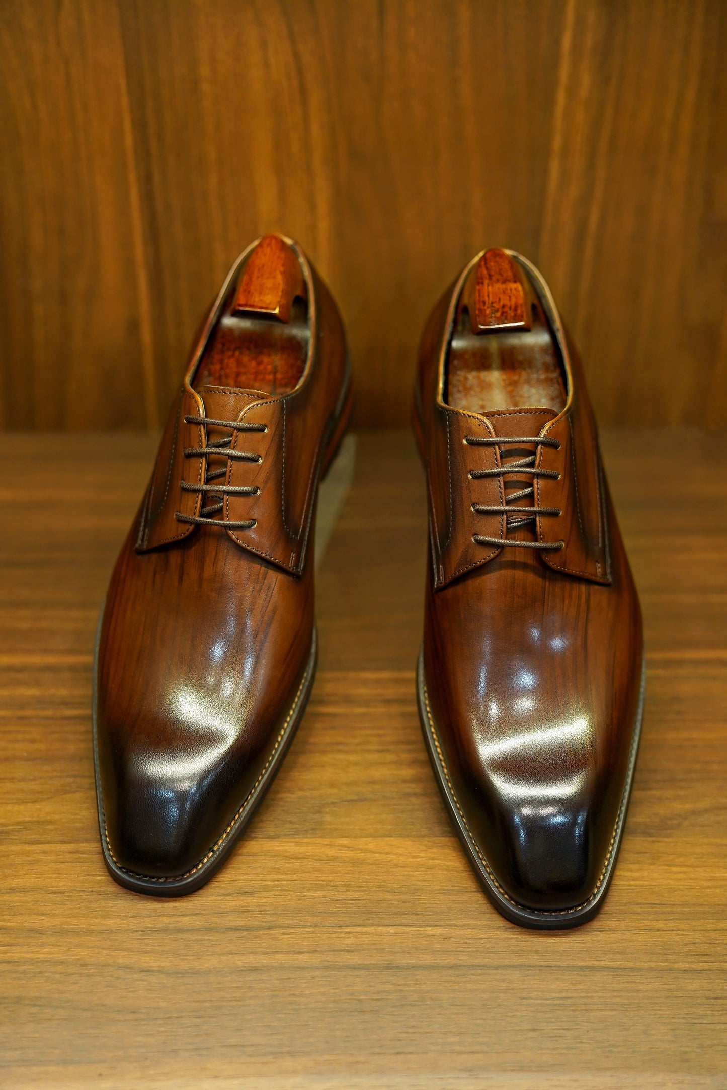 A pair of handcrafted brown leather Derby shoes for men, showcasing a polished finish and elegant design, perfect for formal wear and business occasions.