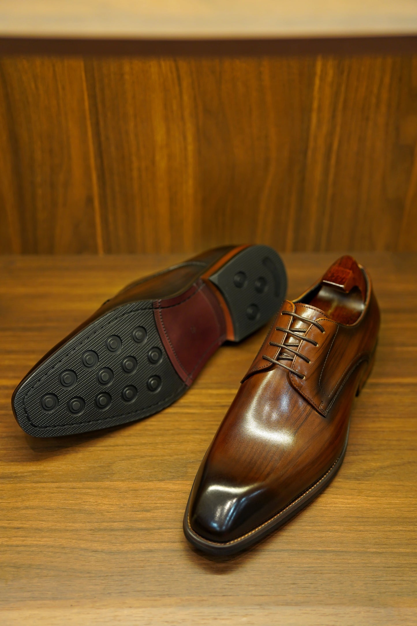 A pair of handcrafted brown leather Derby shoes for men, showcasing a polished finish and elegant design, perfect for formal wear and business occasions.