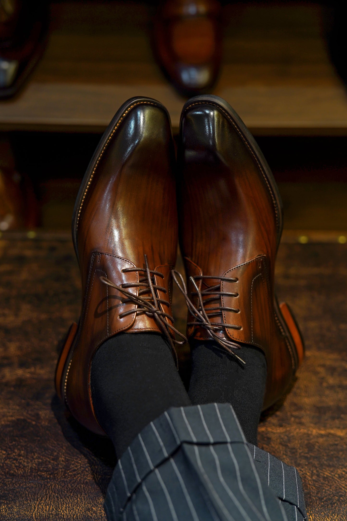 A pair of handcrafted brown leather Derby shoes for men, showcasing a polished finish and elegant design, perfect for formal wear and business occasions.