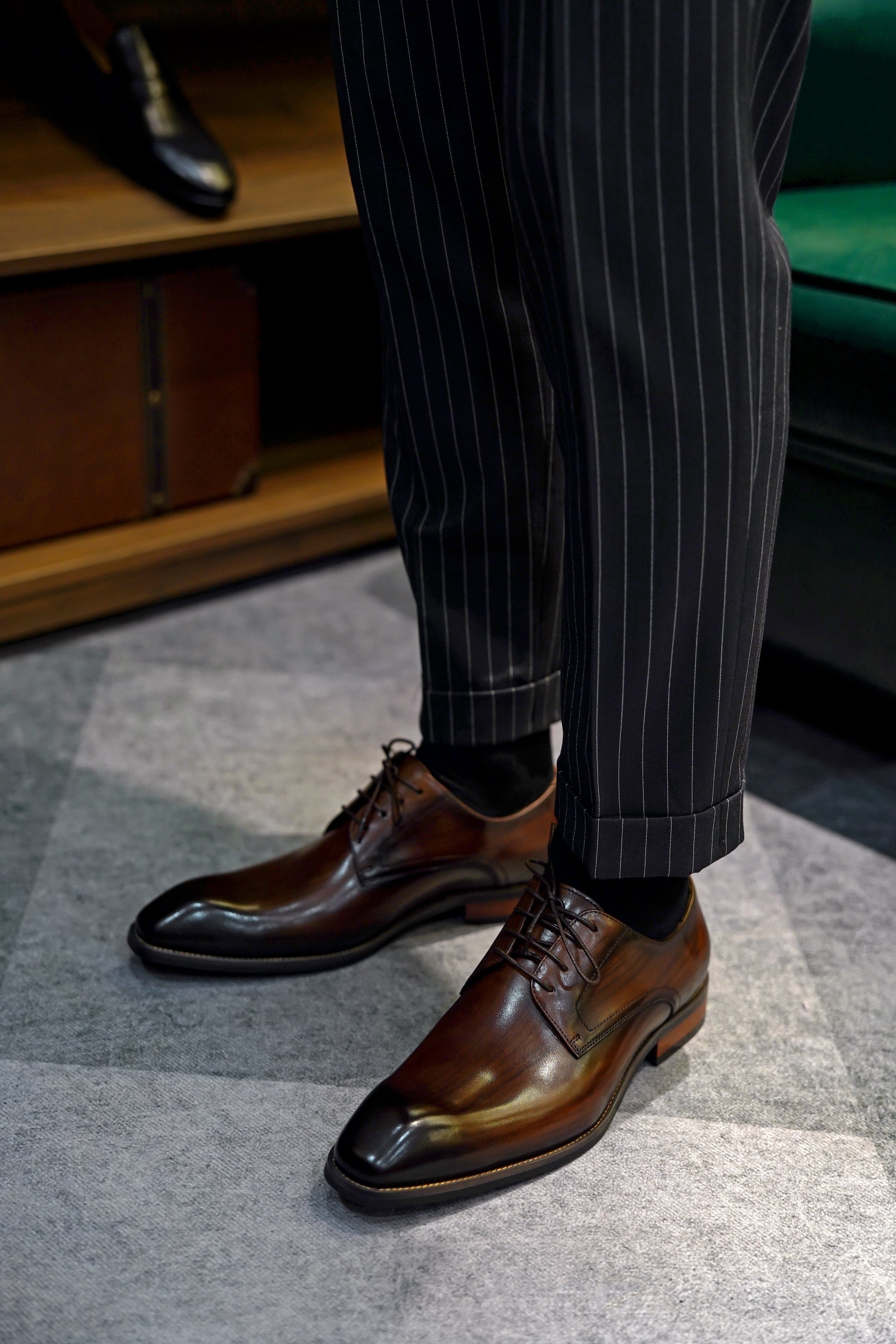 A pair of handcrafted brown leather Derby shoes for men, showcasing a polished finish and elegant design, perfect for formal wear and business occasions.