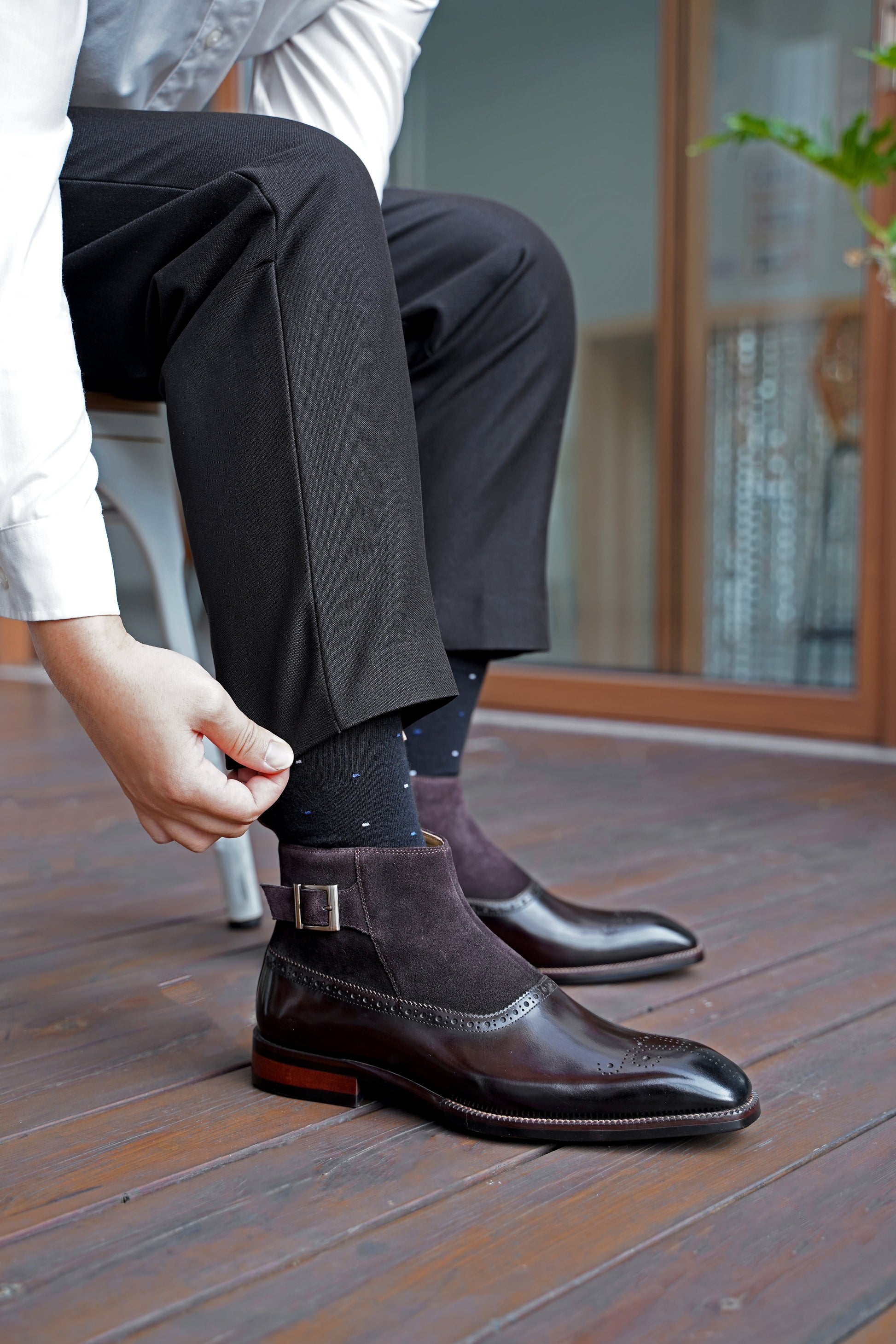 A pair of Men’s Brogue Boots with a combination of suede and polished leather, featuring a zipper and buckle design, perfect for formal and business attire.