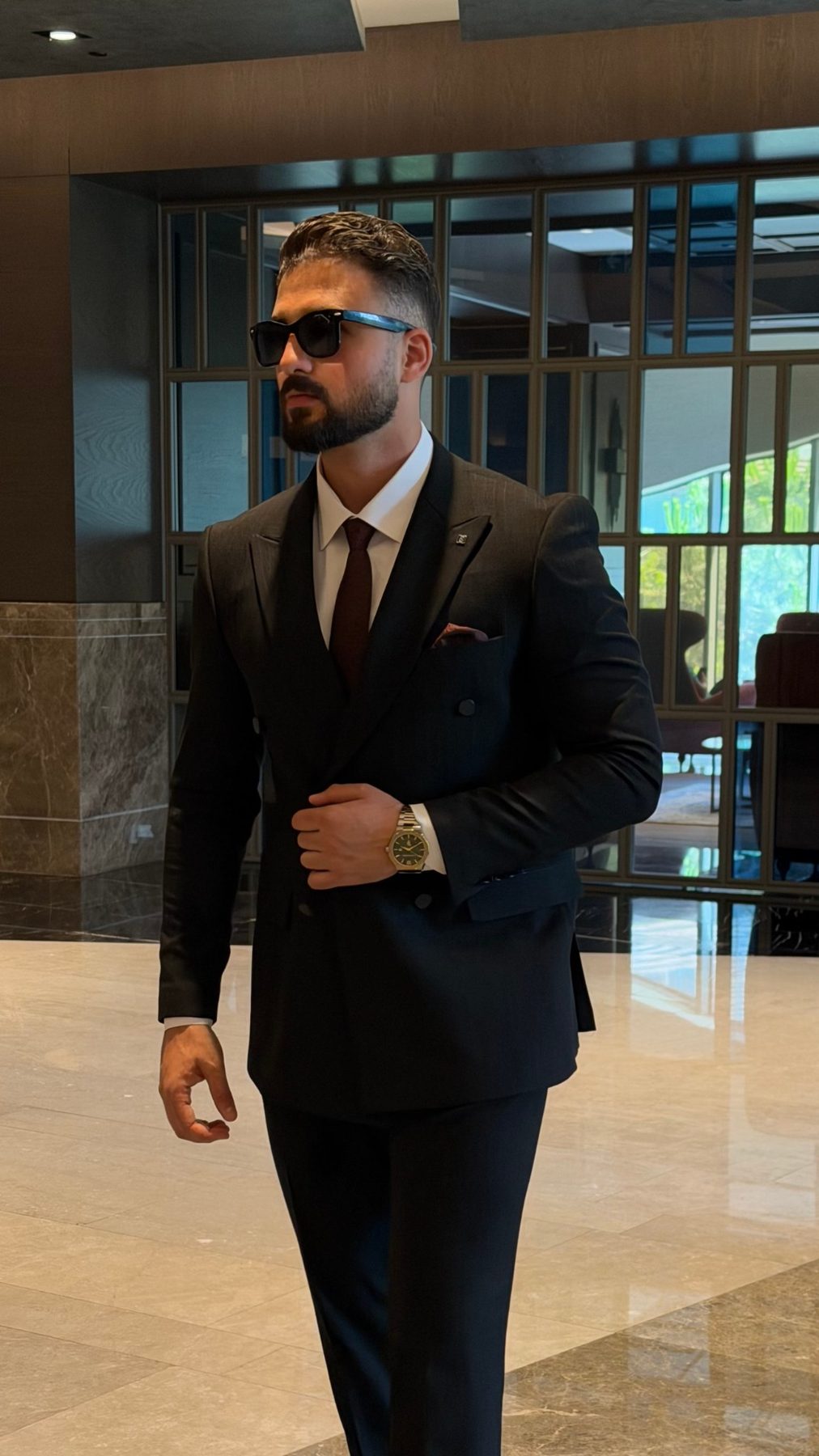 Black pinstripe double-breasted suit peak lapel and fabric detail