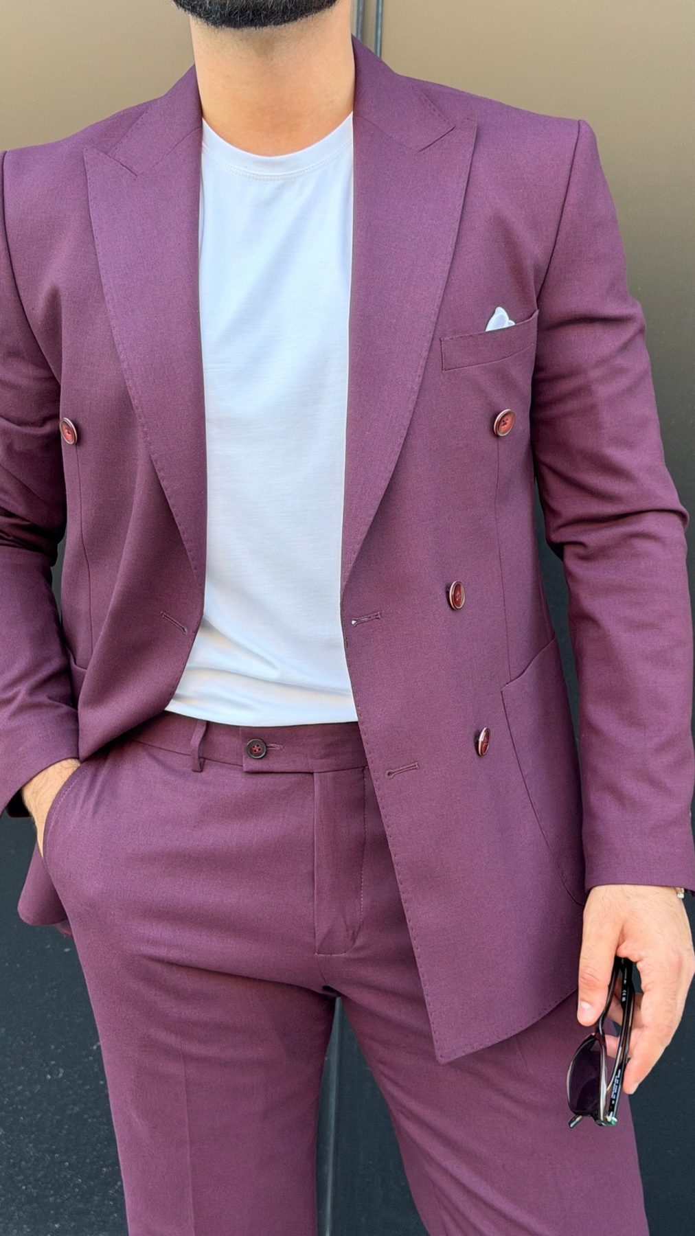 Men's burgundy double-breasted peak lapel suit close-up