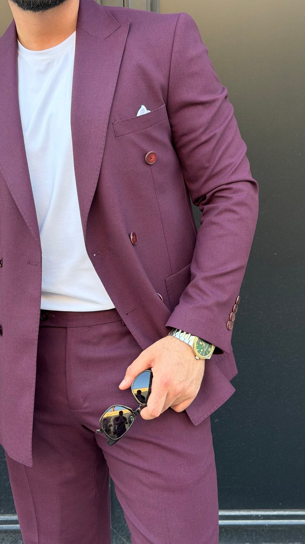 Burgundy double-breasted suit jacket fabric and button detail