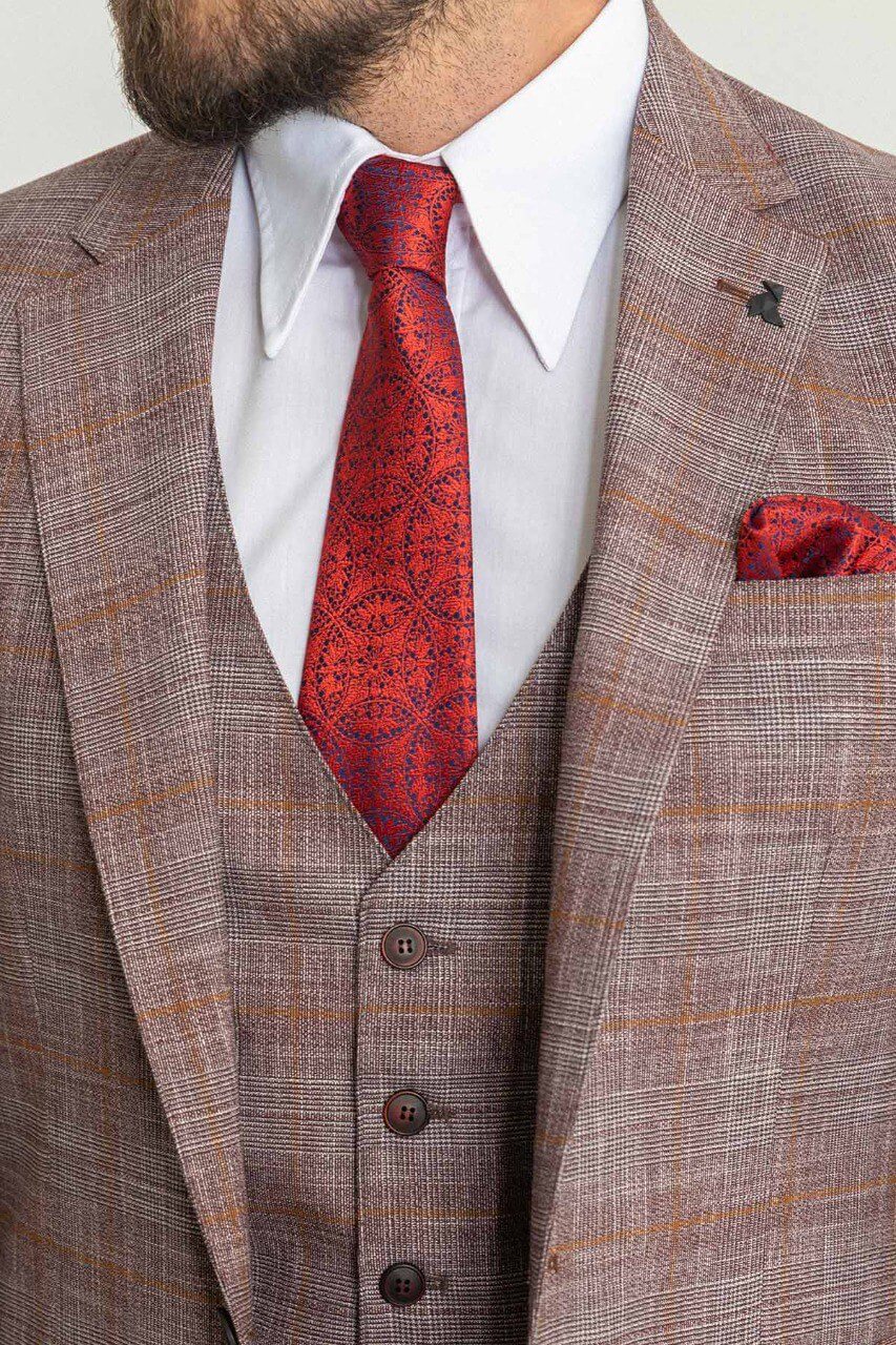 Man wearing a stylish patterned burgundy suit with a red tie and pocket square, showcasing elegant men's formal wear from Suitharbor.