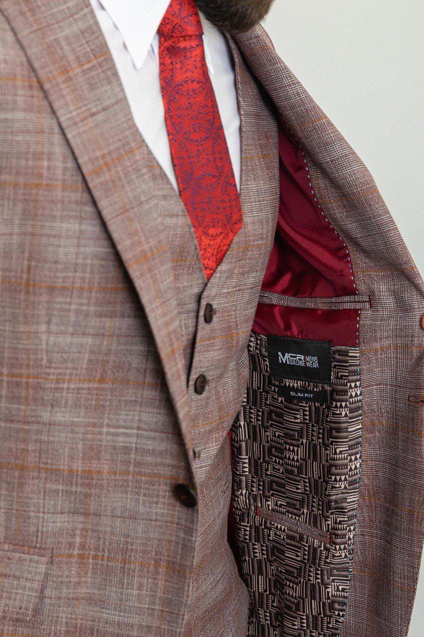 Man wearing a stylish patterned burgundy suit with a red tie and pocket square, showcasing elegant men's formal wear from Suitharbor.