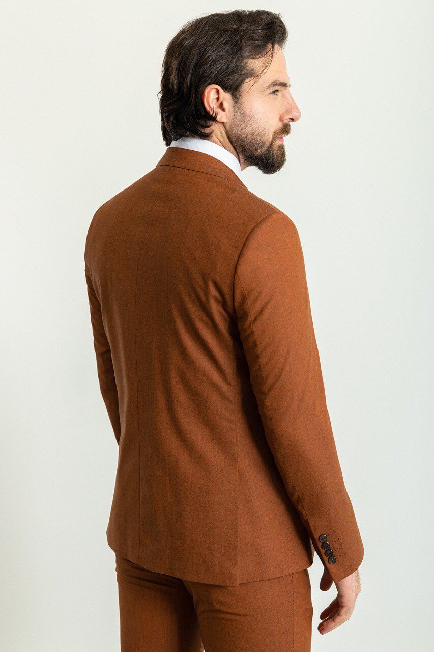 Man wearing a stylish camel suit, showcasing timeless elegance.