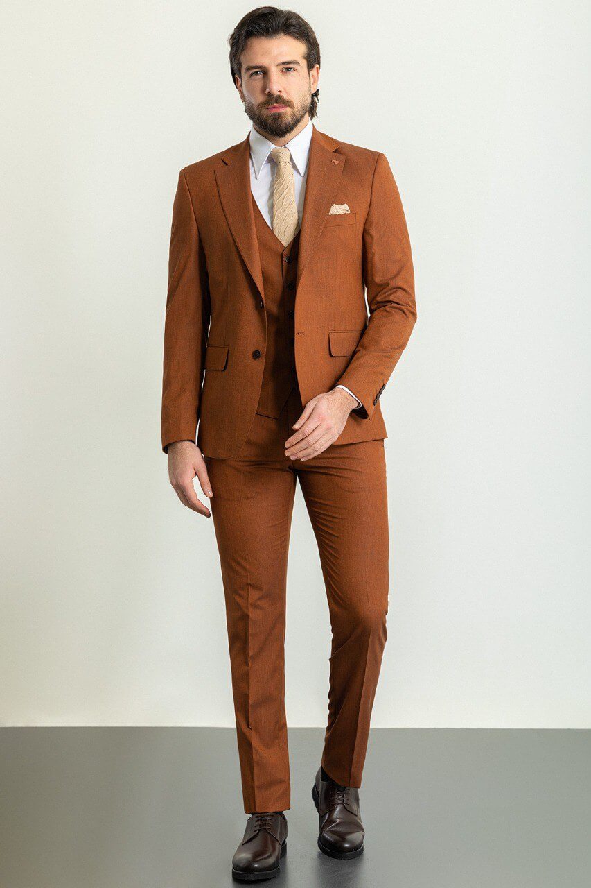 Man wearing a stylish camel suit, showcasing timeless elegance.