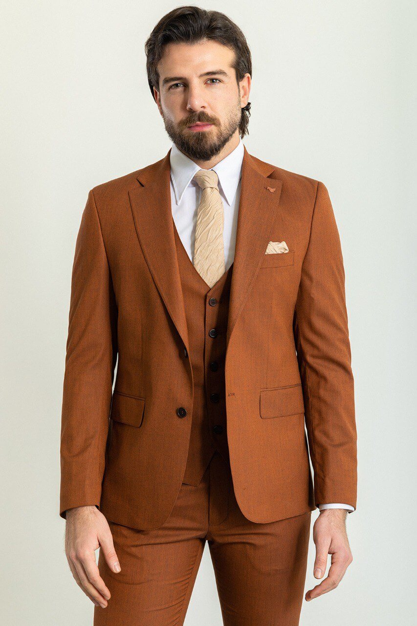 Man wearing a stylish camel suit, showcasing timeless elegance.