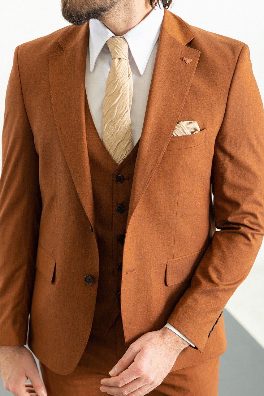 Man wearing a stylish camel suit, showcasing timeless elegance.