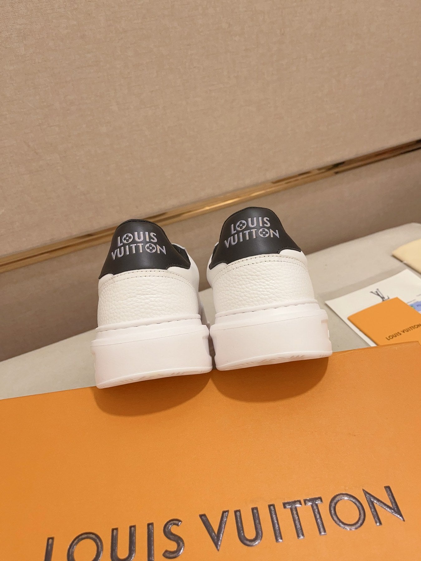 Louis Vuitton white and black logo low-top sneakers rear heel view