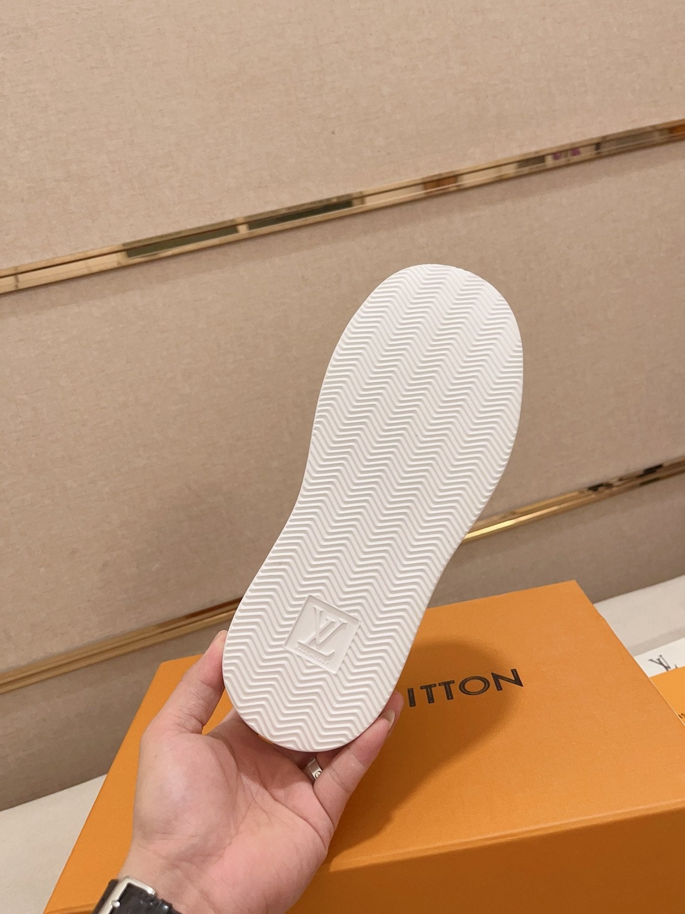 Louis Vuitton white and blue logo low-top sneakers outsole tread view