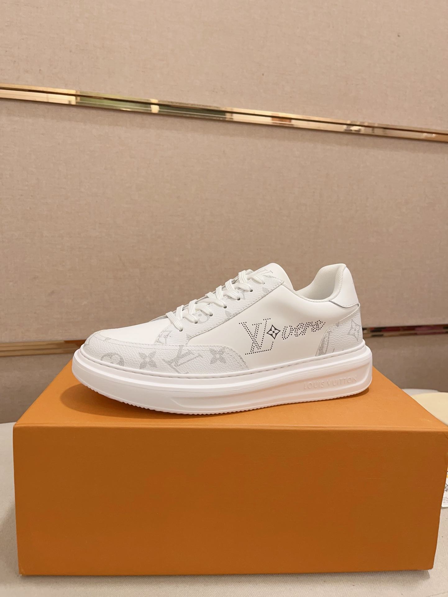 Louis Vuitton white and grey Monogram low-top sneakers side profile on orange box