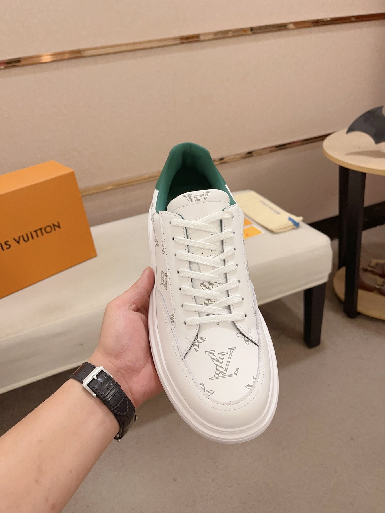 Louis Vuitton white monogram green heel low-top sneakers front top view held in hand