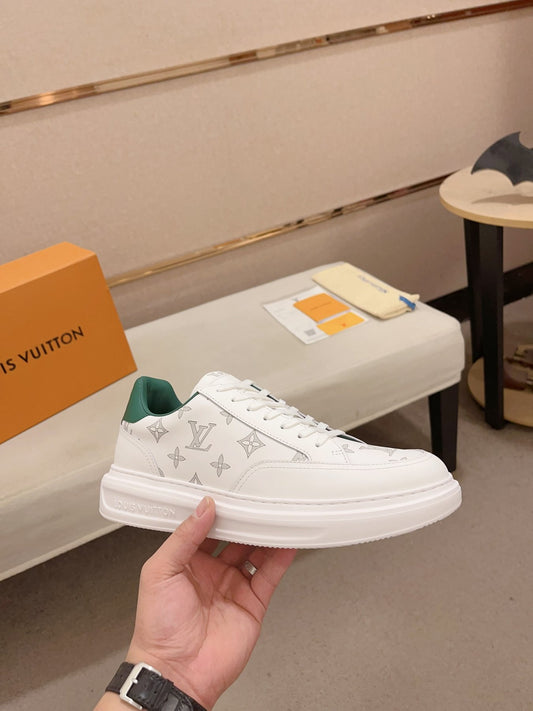 Louis Vuitton white monogram green heel low-top sneakers side profile held in hand