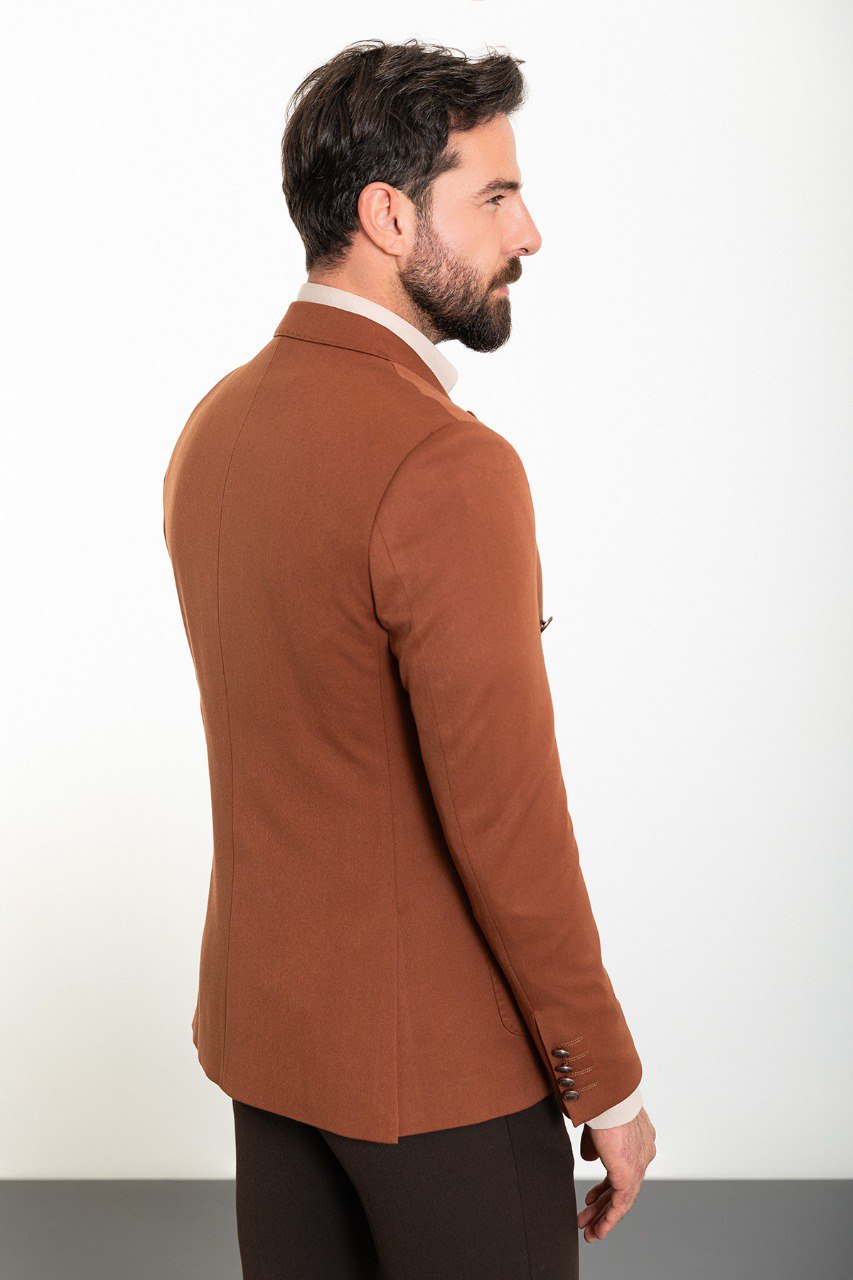 Man in a stylish brown double-breasted blazer paired with a beige shirt.