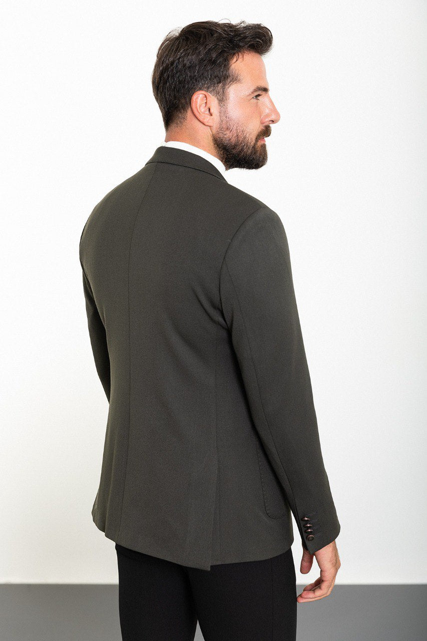 Man wearing a gray double-breasted blazer paired with a white turtleneck.