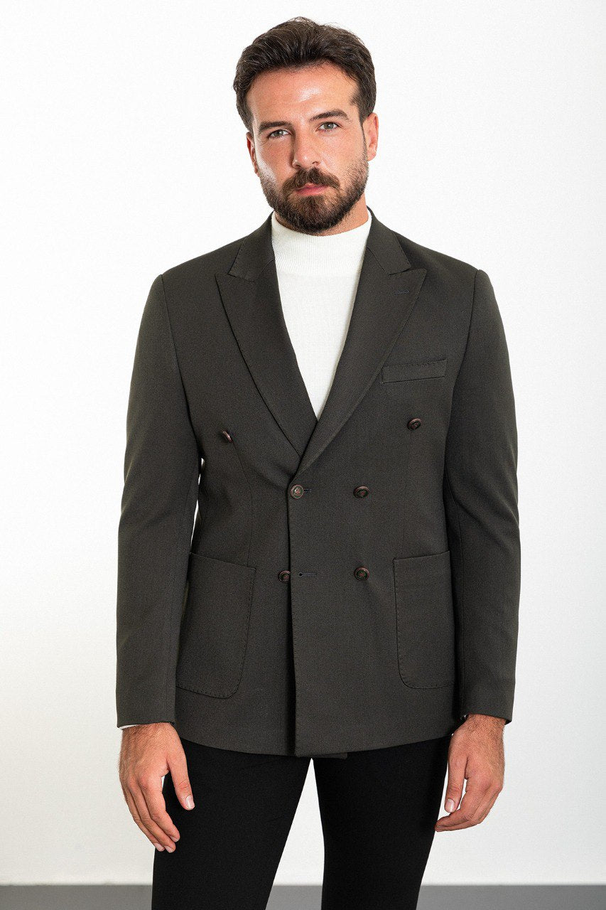 Man wearing a gray double-breasted blazer paired with a white turtleneck.
