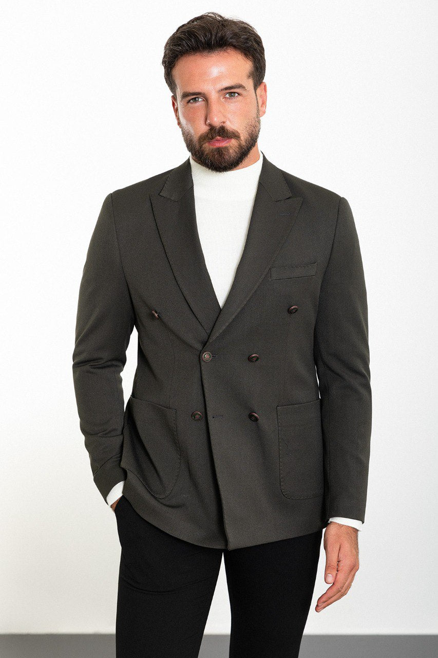 Man wearing a gray double-breasted blazer paired with a white turtleneck