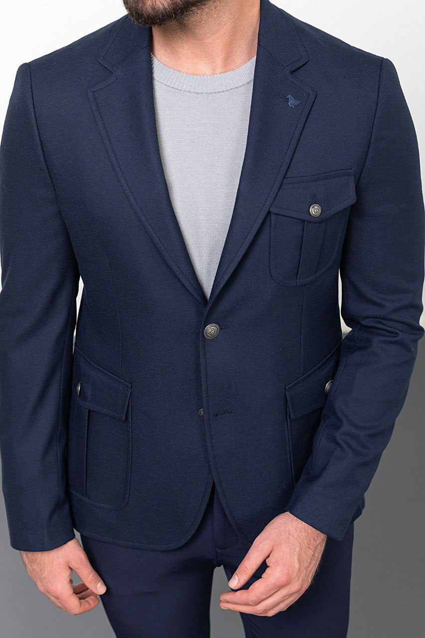 Man wearing a navy blue blazer with a light grey shirt, perfect for a smart-casual or business outfit, showcasing tailored elegance and modern style.