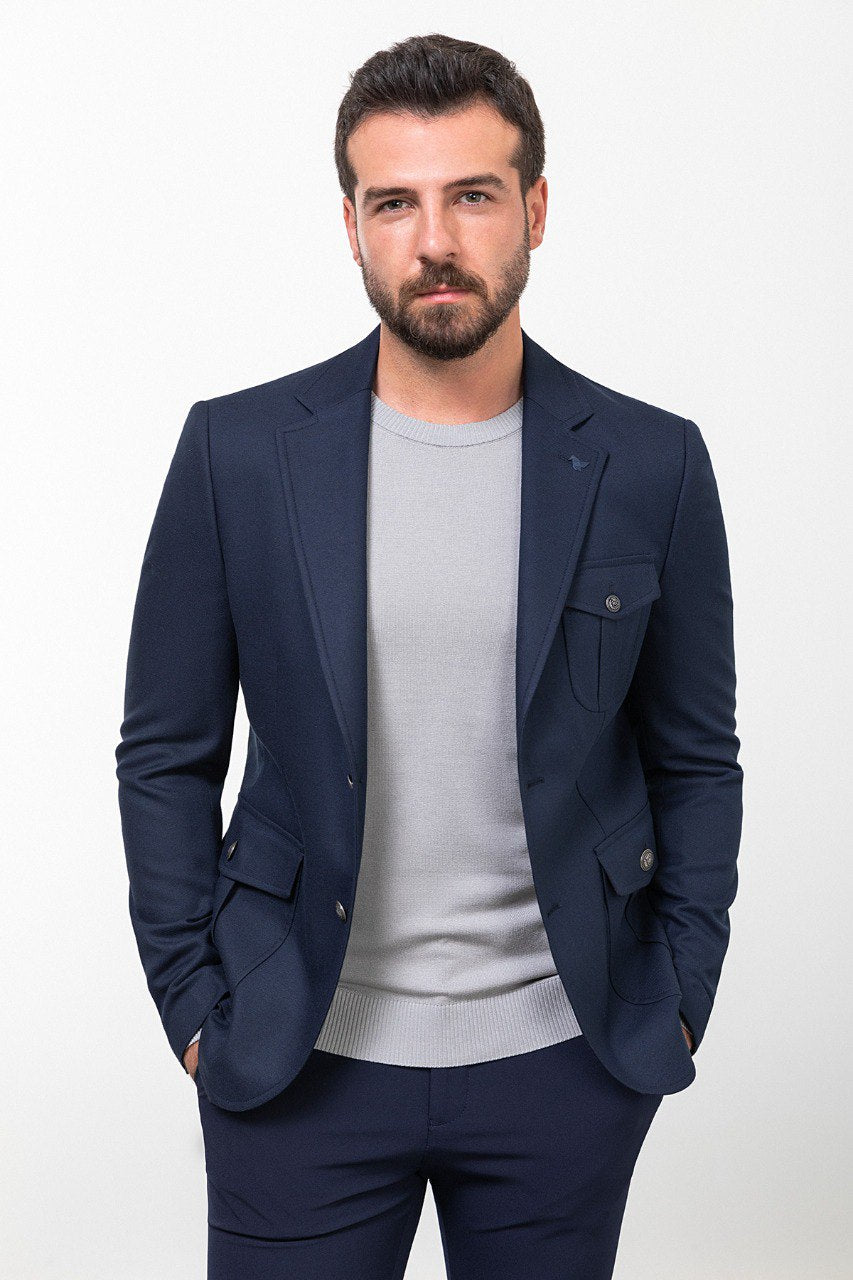 Man wearing a navy blue blazer with a light grey shirt, perfect for a smart-casual or business outfit, showcasing tailored elegance and modern style.