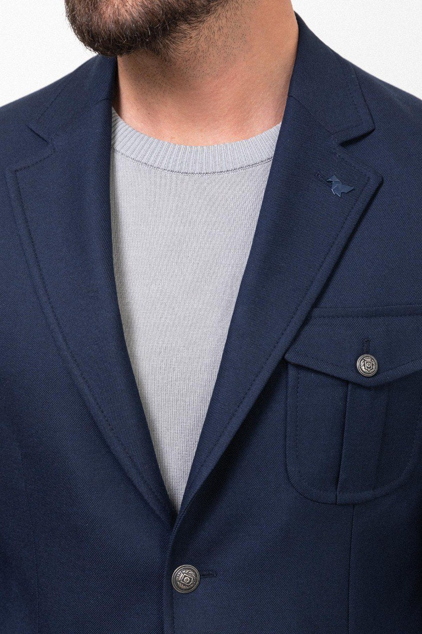 Man wearing a navy blue blazer with a light grey shirt, perfect for a smart-casual or business outfit.