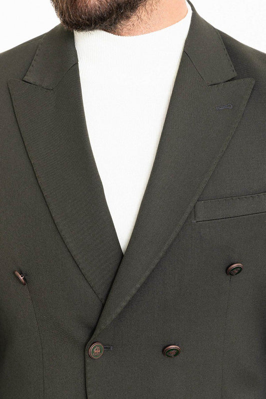 Man wearing a gray double-breasted blazer paired with a white turtleneck.
