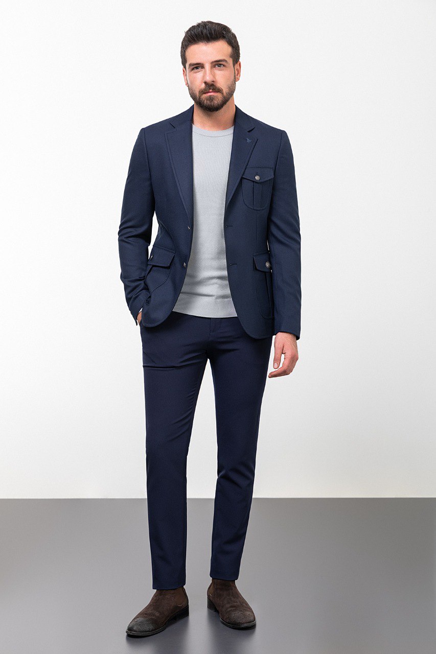 Man wearing a navy blue blazer with a light grey shirt, perfect for a smart-casual or business outfit, showcasing tailored elegance and modern style.