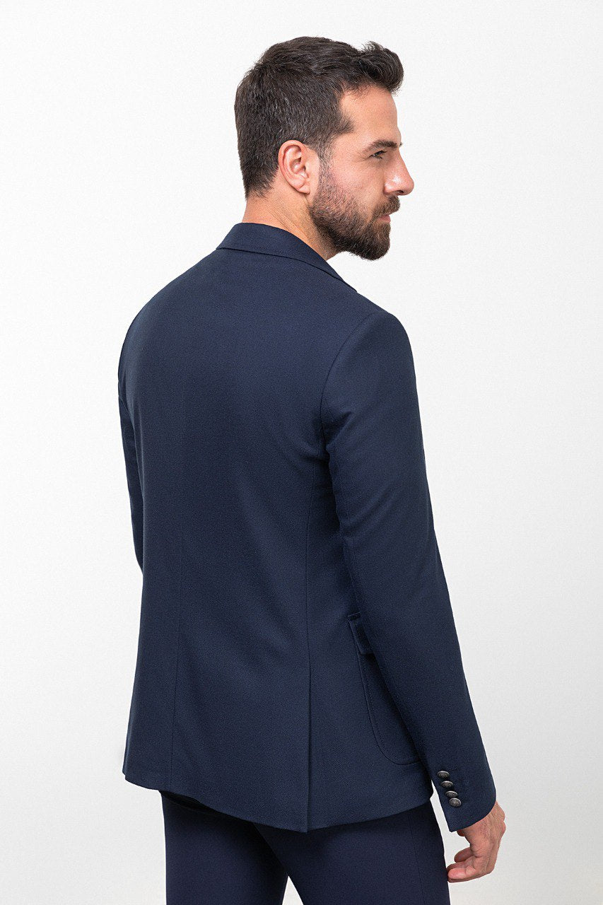 Man wearing a navy blue blazer with a light grey shirt, perfect for a smart-casual or business outfit, showcasing tailored elegance and modern style.