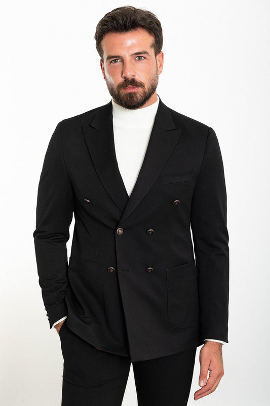 Man wearing a black double-breasted blazer with a white turtleneck, showcasing a modern and sophisticated look for formal or smart-casual occasions.