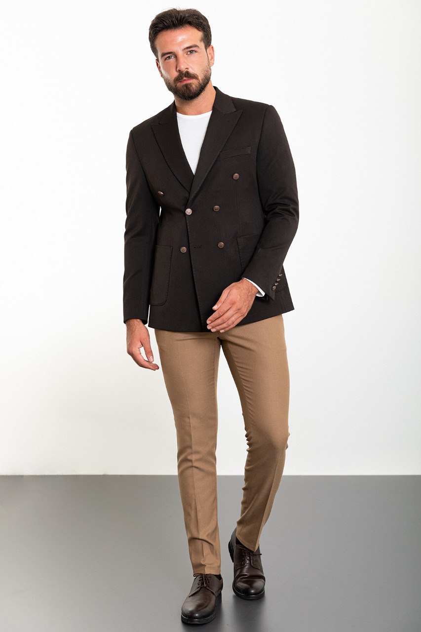 Man wearing a brown double-breasted blazer paired with beige trousers, showcasing a modern and elegant business-casual look.