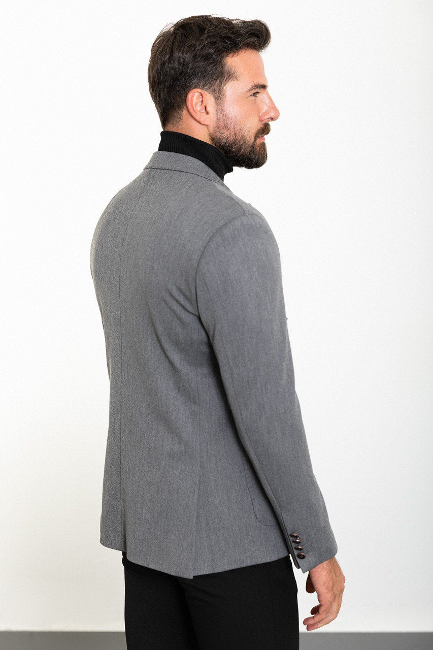 Man wearing a grey double-breasted blazer paired with a black turtleneck, ideal for smart-casual and formal occasions.